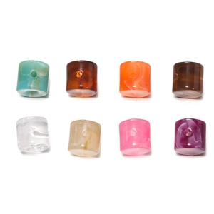 Macro view of multi-colored acrylic cylinder beads with marble pattern for DIY jewelry