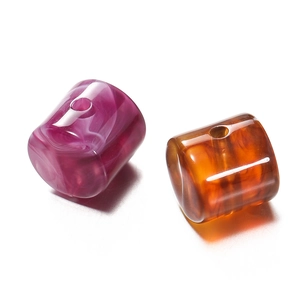 Macro detail of acrylic cylinder beads with marble and tortoiseshell patterns for DIY
