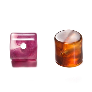 Macro detail of marble-textured acrylic cylinder beads for DIY jewelry making