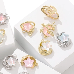 Macro view of star and moon alloy pendants with sparkling rhinestones for DIY jewelry crafts