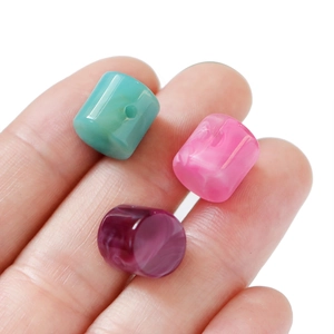 Macro detail of acrylic marble texture cylinder beads for DIY jewelry making