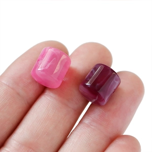 Macro shot of pink and purple marble pattern acrylic beads for DIY jewelry making