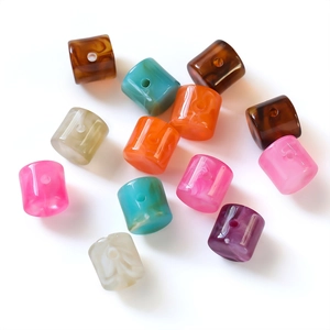 Macro view of assorted cylinder acrylic beads with marble texture for DIY jewelry making