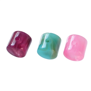 Macro detail of acrylic marble-textured cylinder beads for DIY jewelry with large holes