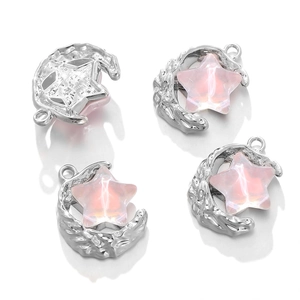 Detail of silver moon pendants with pink star stone inserts for DIY jewelry design