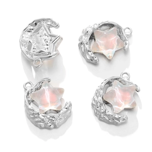 Close-up of crescent moon and star alloy pendants with iridescent pink resin inlay