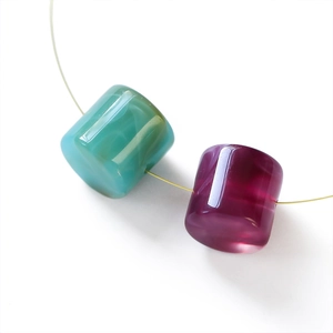 Detail of cylindrical acrylic marble texture beads for DIY jewelry making and chains