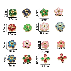 Macro view of assorted 18K gold-plated floral bead caps with colorful enamel for DIY jewelry