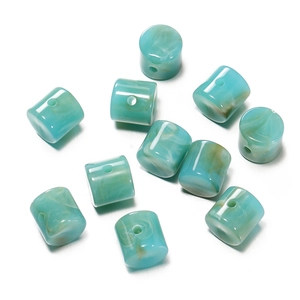 Macro shot of light blue acrylic cylinder beads with white marble texture for DIY jewelry