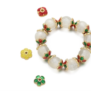 Detailed macro view of 18K matte gold enamel flower spacer beads for DIY jewelry making