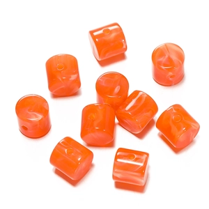 Macro detail of orange translucent acrylic cylinder beads with white marble texture
