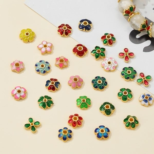 Macro shot of 10mm flower enamel spacers in various colors for DIY jewelry making