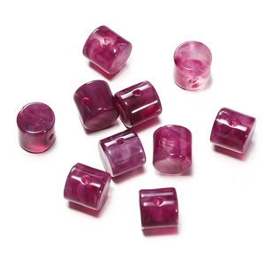 Detail of magenta acrylic barrel beads with white marble texture for DIY jewelry making