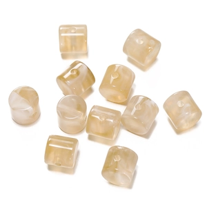 Close-up of cream marble cylinder acrylic beads for DIY jewelry and necklaces