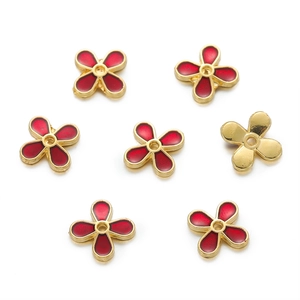Macro view of 10mm red enamel and gold flower spacers for DIY jewelry bracelets