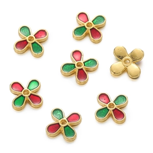 Detailed macro of red and green enamel flower spacers for DIY jewelry making