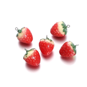 Macro shot of 5 resin strawberry charms with green leaves and silver metal hooks