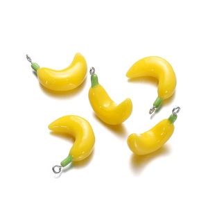 Detailed view of banana-shaped resin pendants with metallic loops for DIY jewelry making