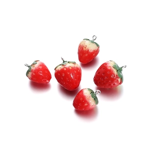 Detailed view of realistic resin strawberry charms with silver loops for DIY jewelry making