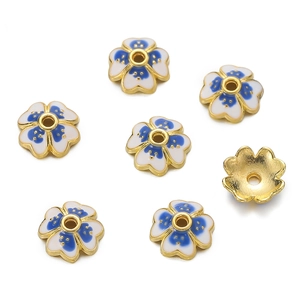 Macro shot of 10mm white enamel flower bead caps with blue dots for DIY jewelry making
