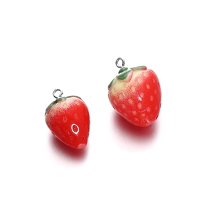 Macro detail of realistic resin strawberry charms with glossy finish and metal loop hooks