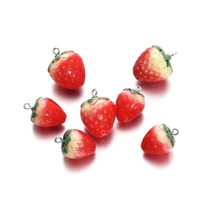 Close-up of resin strawberry charms with realistic texture and silver metal hanging rings
