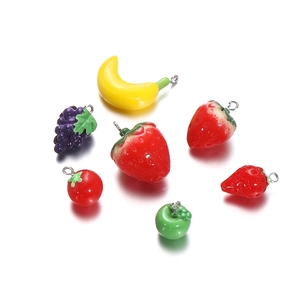 Detailed macro view of assorted resin fruit charms with glossy finish and metal hooks