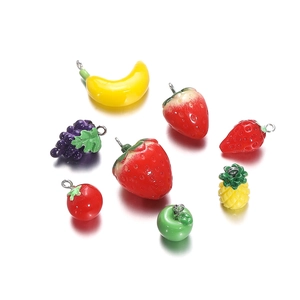 Macro detail of colorful resin fruit and vegetable pendants for DIY jewelry making