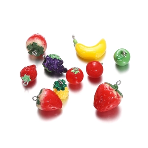 Macro view of assorted resin fruit pendants with metal rings for DIY jewelry making
