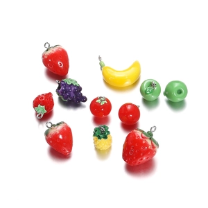 Detailed close-up of assorted resin fruit pendants for DIY earrings and jewelry making