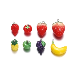 Detailed macro view of assorted resin fruit charms with metal rings for DIY jewelry making