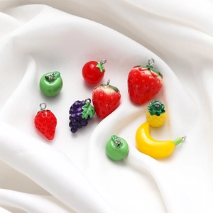 Macro shot of assorted colorful resin fruit charms with metal loops for DIY jewelry making