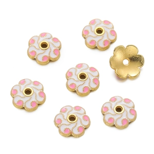 Macro detail of 18K gold-plated flower bead caps with pink enamel and dot patterns