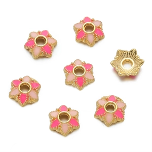 Detailed view of 18K gold-plated flower bead caps with pink enamel for DIY jewelry making