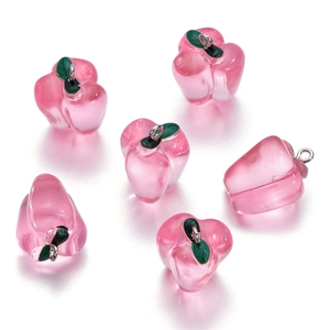 Detailed view of six pink resin apple charms with green leaves and metal rings for DIY jewelry