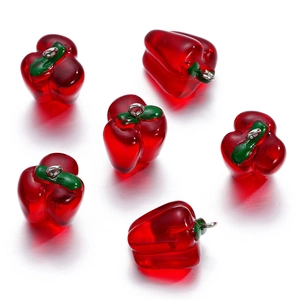 Close-up of six red resin bell pepper charms with silver rings for DIY jewelry making