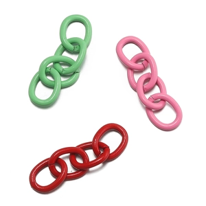 Close-up of matte colorful metal chains in green, pink, and red for DIY keyrings