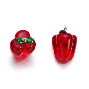 Close-up of translucent red bell pepper resin charms with silver rings for DIY jewelry