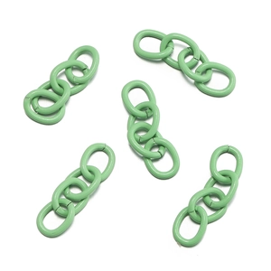 Detail of pea green matte metal chain links with four oval rings for DIY crafts