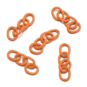 Close-up of orange matte links for DIY keychains and accessory extensions