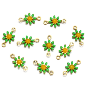 Detail of gold floral connectors with green petals and yellow centers for DIY jewelry