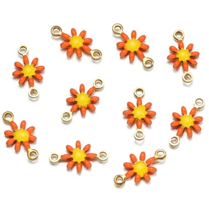 Detail of 10 orange daisy enamel charms with golden metal connectors for DIY jewelry making