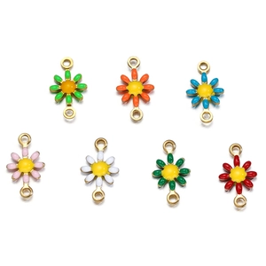 Detailed view of colorful enamel daisy flower pendants with double rings for jewelry making