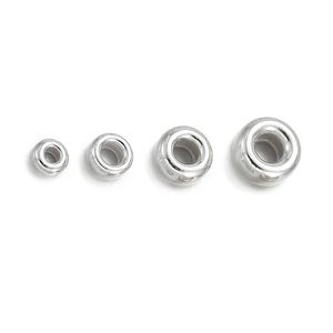 Macro shot of 925 sterling silver spacer beads in four sizes for DIY jewelry making
