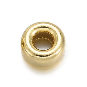 Macro view of a gold-plated round donut bead spacer for DIY jewelry making