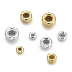Detailed view of silver and gold 925 sterling silver flat round bubble beads for DIY jewelry