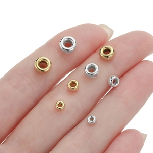 925 silver and gold bubble beads for jewelry making shown in various sizes on a finger
