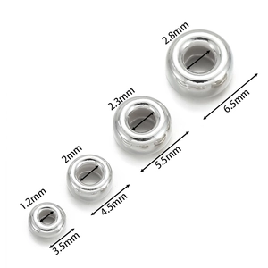 Macro view of 925 sterling silver spacer beads showing four sizes with polished finish