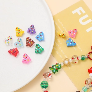 Macro detail of DIY resin Christmas tree beads with colorful hand-painted polka dots