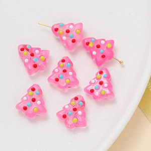 Detail showing pink translucent Christmas tree resin beads with colorful hand-painted dots